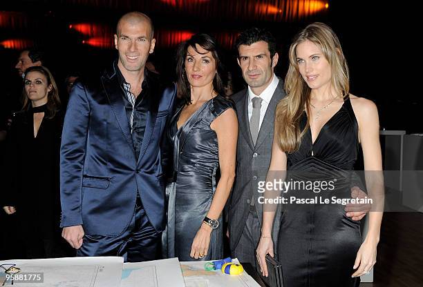 Former French footballer Zinedine Zidane and wife Veronique Zidane pose with former Portuguese footballer Luis Figo and wife Helen Svedin at the IWC...