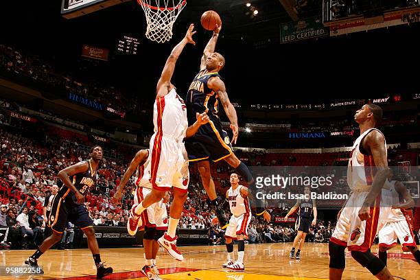 Dahntay Jones of the Indiana Pacers shoots against Jamaal Magloire of the Miami Heat on January 19, 2010 at American Airlines Arena in Miami,...