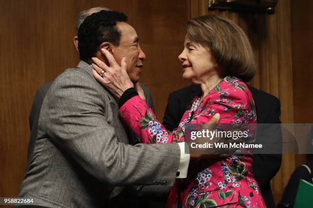 Singer and songwriter Smokey Robinson embraces Sen. Dianne Feinstein prior to a hearing of the Senate Judiciary Committee May 15, 2018 in Washington,...