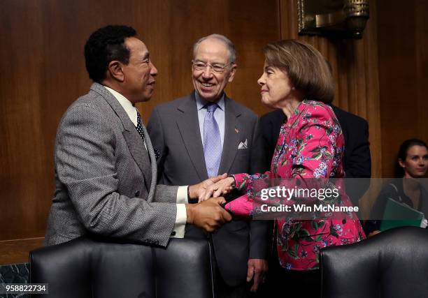 Singer and songwriter Smokey Robinson embraces Sen. Dianne Feinstein as committee chairman Sen. Chuck Grassley looks on prior to a hearing of the...