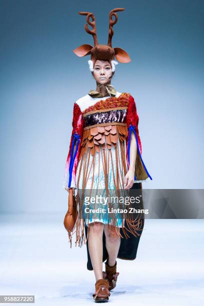 Model showcases designs on runway at Apparel & Art Design College, Xi'an Polytechnic University show during China International College Student...