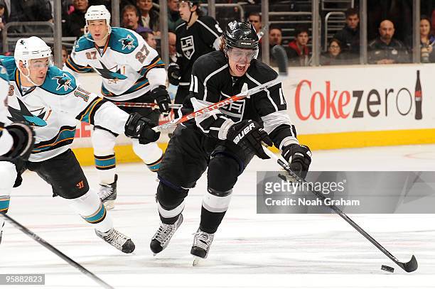 Anze Kopitar of the Los Angeles Kings skates with the puck against Devin Setoguchi of the San Jose Sharks on January 19, 2010 at Staples Center in...