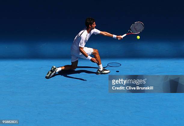 Thomaz Bellucci of Brazil plays a forehand in his second round match against Andy Roddick of the United States of America during day three of the...