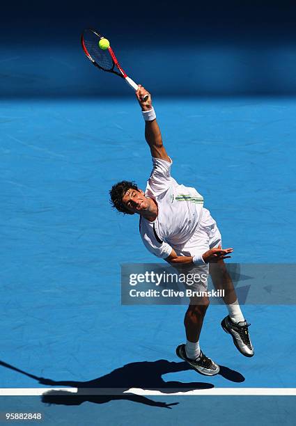 Thomaz Bellucci of Brazil serves in his second round match against Andy Roddick of the United States of America during day three of the 2010...