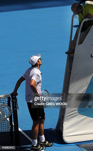 Tennis player Andy Roddick speaks with the umpire during his men's singles match against Brazilian opponent Thomaz Bellucci on the third day of play...