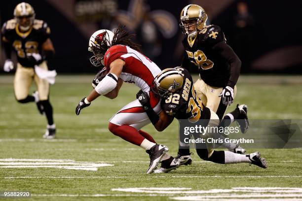 Jabari Greer of the New Orleans Saints tackles Larry Fitzgerald of the Arizona Cardinals during the NFC Divisional Playoff Game at Louisana Superdome...