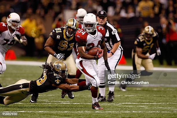 Tim Hightower of the Arizona Cardinals runs the ball against Usama Young of the New Orleans Saints during the NFC Divisional Playoff Game at Louisana...
