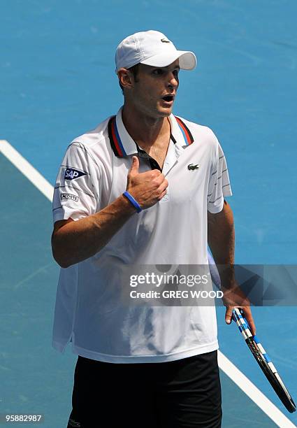 Tennis player Andy Roddick gestures as he speaks with the umpire during his men's singles match against Brazilian opponent Thomaz Bellucci on the...