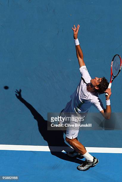 Thomaz Bellucci of Brazil serves in his second round match against Andy Roddick of the United States of America during day three of the 2010...