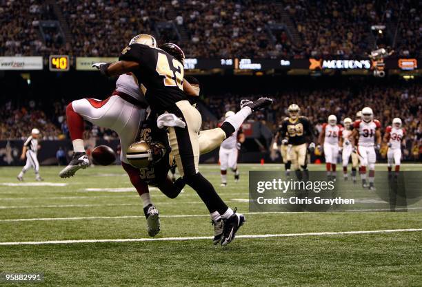 Larry Fitzgerald of the Arizona Cardinals fails to come a reception in the endzone against Jabari Greer and Darren Sharper of the New Orleans Saints...