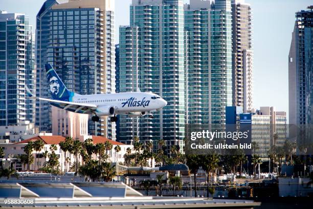 Boeing 737 of Alaska Airlines approaching Lindbergh Field, with the North San Diego Bay in the background.