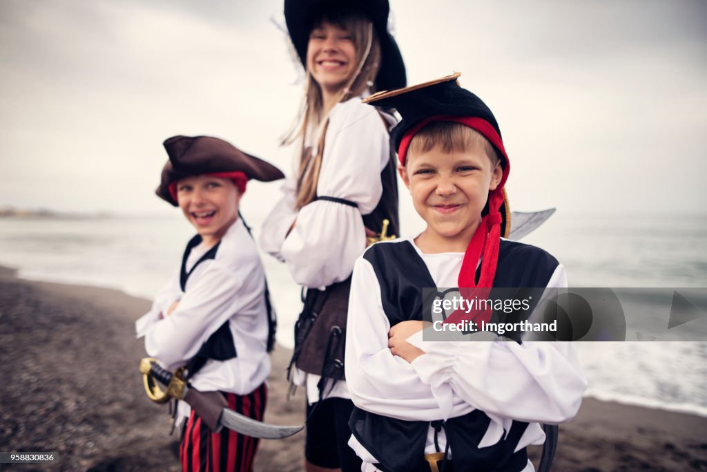 Kids playing pirates on a beach