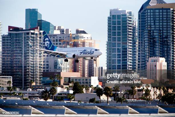 Boeing 737 of Alaska Airlines approaching Lindbergh Field, with the North San Diego Bay in the background.