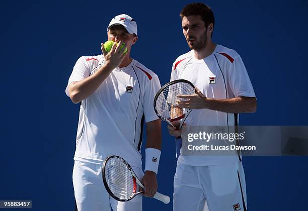 Ken Skupski and Colin Fleming of Great Britain talk tactics in their first round doubles match against Yen-Hsun Lu of Chinese Taipei and Janko...