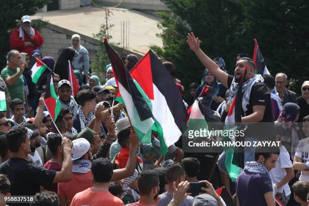 Protesters including Lebanese nationals and Palestinian refugees living in Lebanon chant slogans and wave Palestinian flags during a demonstration in...