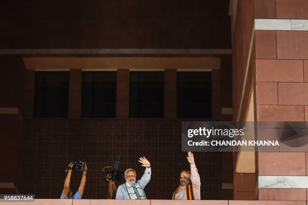 Indian Prime Minister Narendra Modi and Bhartiya Janta Party President Amit Shah wave to party supporters during the celebration meet ahead of wining...