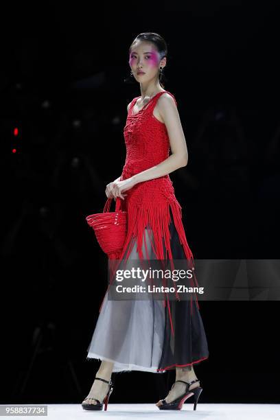 Model showcases designs on runway at Changzhou Vocational Institute Of Textile And Garment show during China International College Student Fashion...