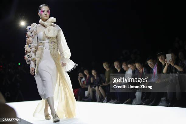 Model showcases designs on runway at Changzhou Vocational Institute Of Textile And Garment show during China International College Student Fashion...