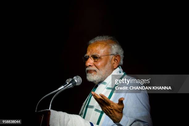 Indian Prime Minister Narendra Modi addresses party supporters during a celebration event ahead of wining the Karnataka election in New Delhi on May...