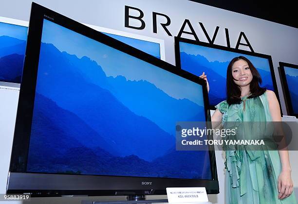 Model shows off the new lineup of Sony's liquid crystal display TV Bravia "EX700" series during a press conference at the headquarters of the...