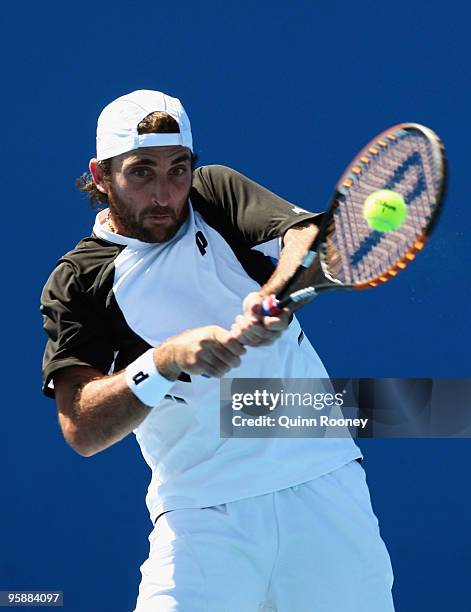 Santiago Ventura of Spain plays a backhand in his first round doubles match with Marc Lopez of Spain against Jurgen Melzer of Austria and Philipp...
