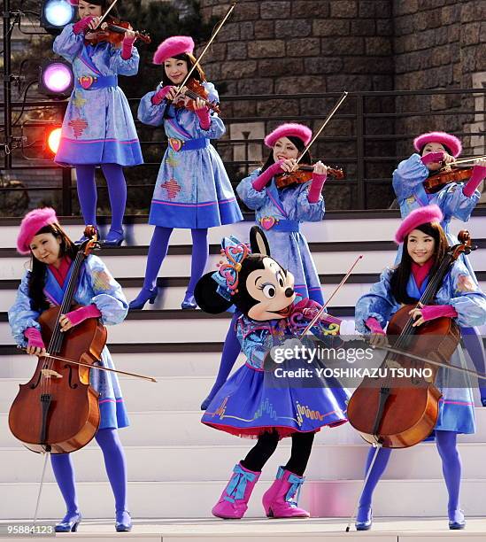 Minnie Mouse plays the violin with female musicians for the new attraction "Disney Power of Music" at the Tokyo Disneyland at Urayasu city in Chiba...