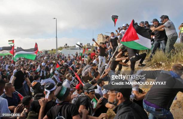 Protesters including Lebanese nationals and Palestinian refugees living in Lebanon wave Palestinian and Lebanese flags during a demonstration in the...