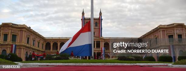 Cadets of Paraguay's Acosta Nu Military Academy raise the national flag at the Palace of the Lopez presidential palace during the 207th anniversary...