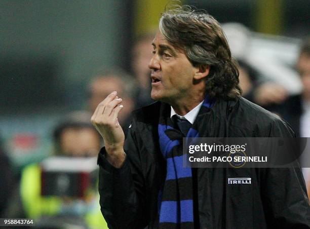 Inter Milan's coach Roberto Mancini reacts against referee Mauro Bergonzi during their Italian serie A football match against Udinese at San Siro...