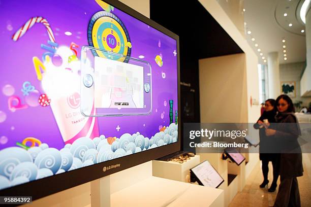 Display Co. Employees look at liquid-crystal display monitors at the venue where the company held a news conference announcing third quarter results...