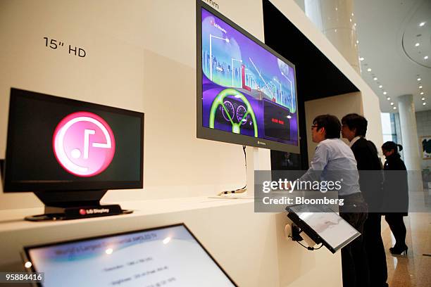 Display Co. Employees check liquid-crystal display monitors at the venue where the company held a news conference announcing third quarter results in...