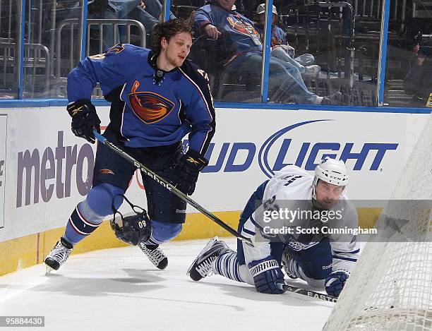 Nik Antropov of the Atlanta Thrashers loses his helmet after colliding with Francois Beauchemin of the Toronto Maple Leafs at Philips Arena on...