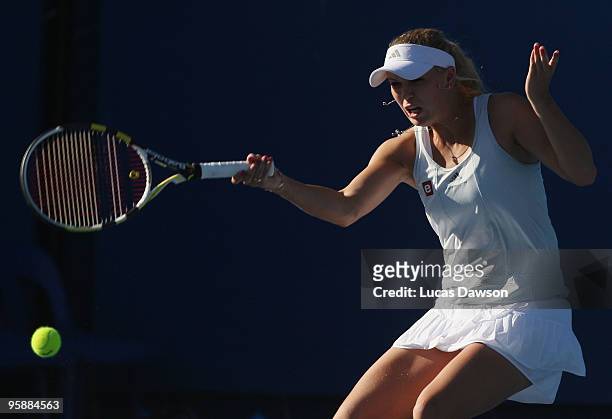 Caroline Wozniacki of Denmark plays a forehand in her first round doubles match with Anabel Medina Garrigues of Spain against Timea Bacsinszky of...