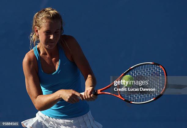 Olivia Rogowska of Australia plays a backhand in her first round doubles match with Jarmila Groth of Australia against Julie Coin of France and...