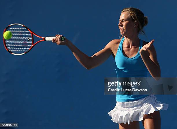 Olivia Rogowska of Australia plays a forehand in her first round doubles match with Jarmila Groth of Australia against Julie Coin of France and...