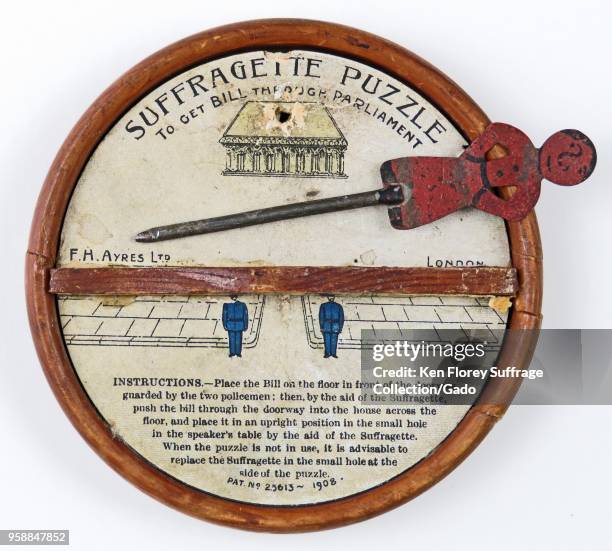 “Suffragette Puzzle To Get Bill Through Parliament” game, with a metal pin, pushed by a red suffragette figure, which would stall at the wooden...