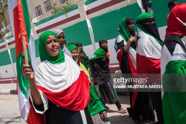 Women wrapped in Somaliland's flags take part in celebrations of the 27th anniversary of self-declared independence of Somaliland in Hargeisa on May...