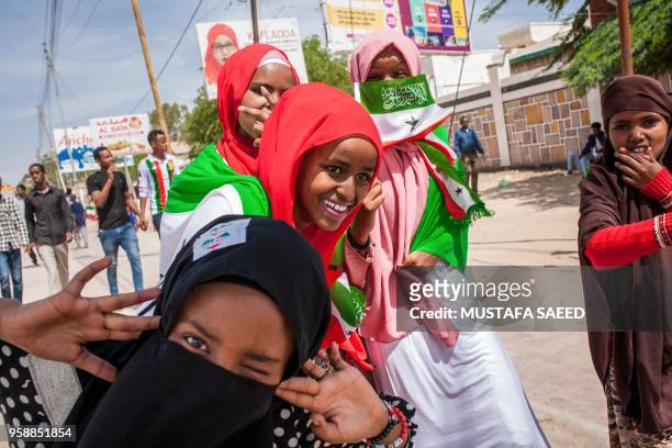 Girls wrapped in Somaliland's flags take part in celebrations of the 27th anniversary of self-declared independence of Somaliland in Hargeisa on May...