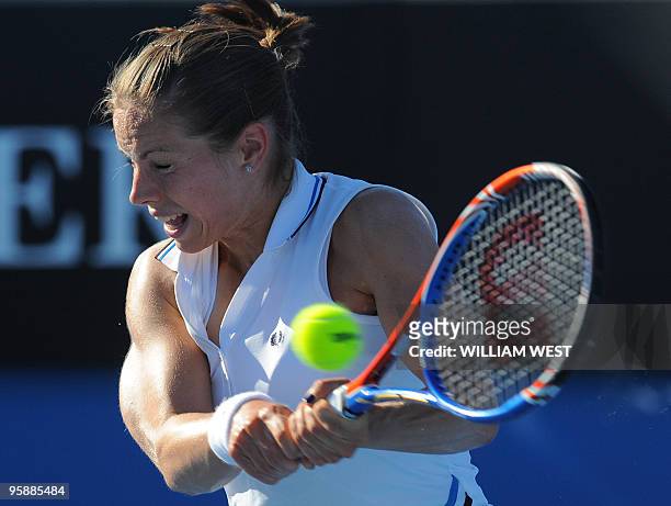 British tennis player Katie O'Brien plays a backhand return during her women's singles match against Serbian opponent Jelena Jankovic on the third...