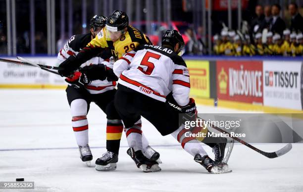 Aaron Ekblad of Canada and Leon Draisaitl of Germany battle for the puck during the 2018 IIHF Ice Hockey World Championship Group B game between...