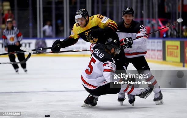 Aaron Ekblad of Canada and Leon Draisaitl of Germany battle for the puck during the 2018 IIHF Ice Hockey World Championship Group B game between...