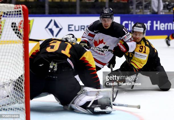 Jean Pageau of Canada and Moritz Mueller of Germany battle for the puck during the 2018 IIHF Ice Hockey World Championship Group B game between...