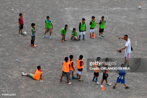 Children practice football on a field in the poor neighbourhood of Nueva Capital, on the outskirts of Tegucigalpa, on May 13, 2018. - Missionaries...