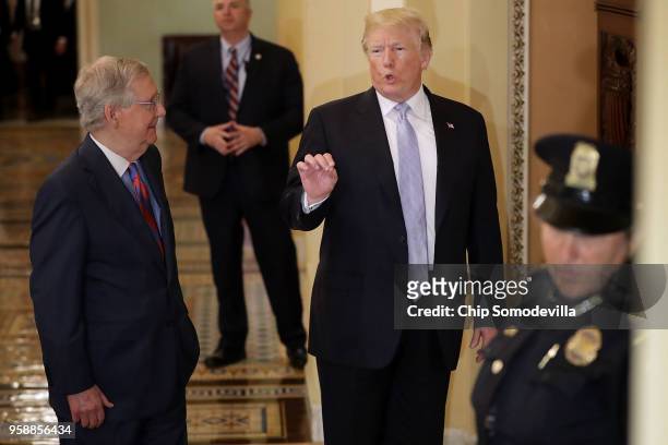 President Donald Trump is escorted by Senate Majority Leader Mitch McConnell to the weekly Senate Republican policy luncheon at the U.S. Capitol May...