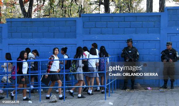 Military Police officers provide security against gang activity at the entrance of a high school in Tegucigalpa, taken on May 13, 2018. -...