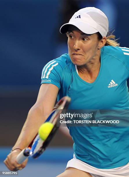 Justine Henin of Belgium hits a return against Elena Dementieva of Russia in their women's singles second round match on day three of the Australian...