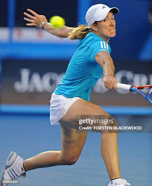 Justine Henin of Belgium hits a return against Elena Dementieva of Russia in their women's singles second round match on day three of the Australian...