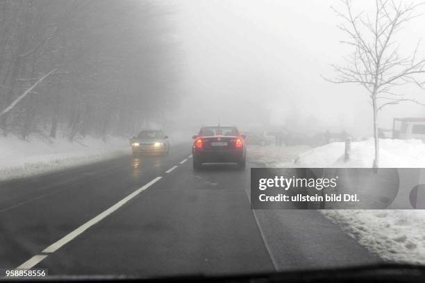 Thueringen, Ilmenau - Wagen auf einer winterlichen , nebligen Landstrasse.