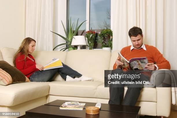 Couple reading magazines