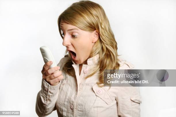 Young woman with a telephone is angry -